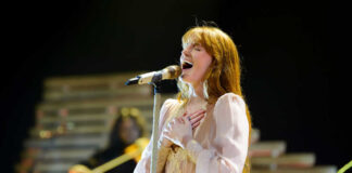 A female singer passionately performing on stage with a microphone