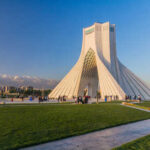 Azadi Tower in Tehran with people gathered around it