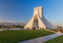 Azadi Tower in Tehran with people gathered around it