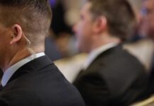 Close-up of a security personnel with an earpiece at an event