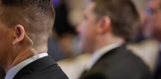 Close-up of a security personnel with an earpiece at an event