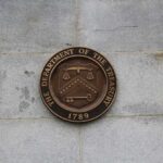 Bronze seal of the Department of the Treasury mounted on a stone wall