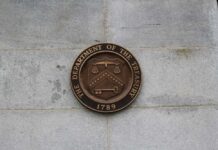 Bronze seal of the Department of the Treasury mounted on a stone wall