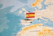 Map highlighting Spain with a small flag