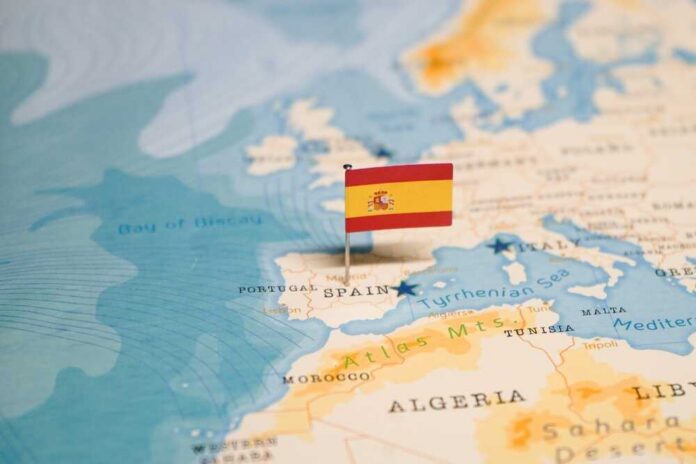 Map highlighting Spain with a small flag