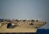 Close-up of an aircraft carrier with fighter jets on deck