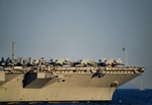 Close-up of an aircraft carrier with fighter jets on deck