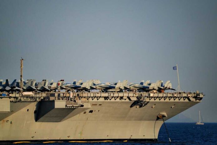 Close-up of an aircraft carrier with fighter jets on deck