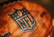 Close-up of an NFL football with the logo and stitching visible