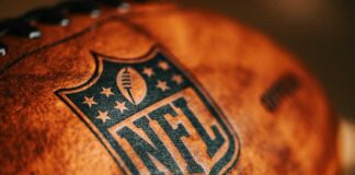 Close-up of an NFL football with the logo and stitching visible