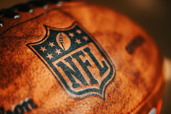 shutterstock_2360209061.jpg Close-up of an NFL football with the logo and stitching visible