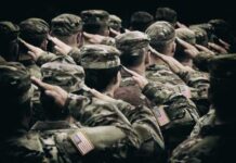 Group of soldiers in uniform saluting during a ceremony