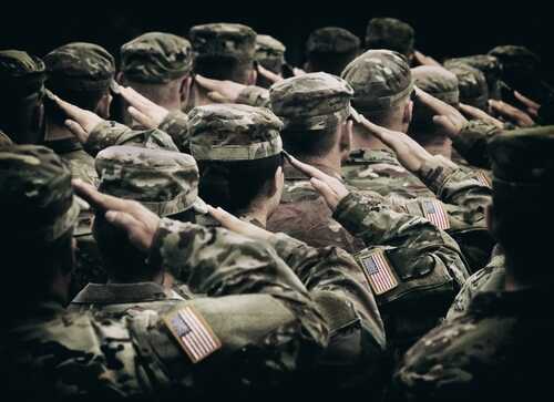 shutterstock_2380882931.jpg Group of soldiers in uniform saluting during a ceremony