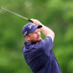 Golfer executing a swing on a lush green course