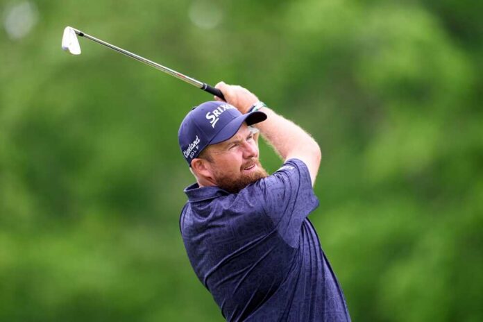 shutterstock_2462331977.jpg Golfer executing a swing on a lush green course