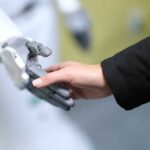 Marathon SHOCK: Robots Beat Humans by MILES! A human hand reaching out to touch a robotic hand