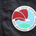 Close-up of a Drug Enforcement Administration badge on a black jacket