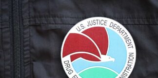 Close-up of a Drug Enforcement Administration badge on a black jacket