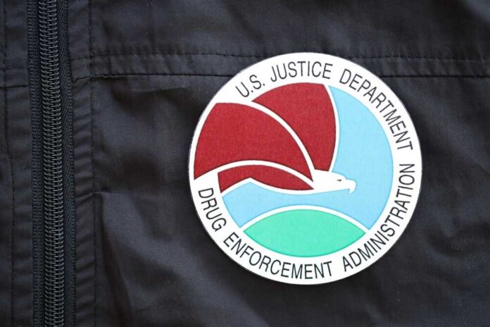 Close-up of a Drug Enforcement Administration badge on a black jacket
