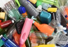 A pile of assorted plastic bottles and containers in various colors