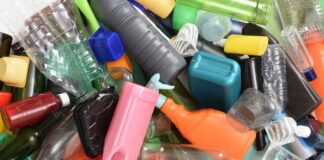 A pile of assorted plastic bottles and containers in various colors