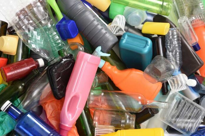 A pile of assorted plastic bottles and containers in various colors