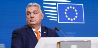 A government official at a podium during a press briefing
