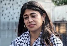 Close-up portrait of a woman in an urban environment wearing a patterned scarf