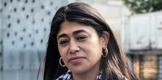 Close-up portrait of a woman in an urban environment wearing a patterned scarf