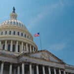 Republicans’ ICE Maneuver – Filibuster Sidestepped! The U.S. Capitol building with an American flag flying against a blue sky