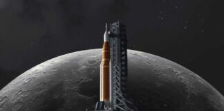 A rocket on a launch pad with the moon in the background