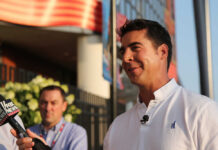 A man being interviewed outdoors with a microphone