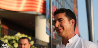 A man being interviewed outdoors with a microphone