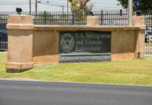 ICE Blamed: Toddler’s Death in Spotlight Sign for U.S. Immigration and Customs Enforcement building.