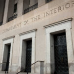 Department of the Interior building facade with tall stone entrances