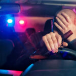 Sensational Quotes Hijack Real Crash Cases Driver holding beer bottle with police lights behind