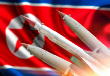 Missiles in front of a North Korean flag