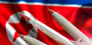 Missiles in front of a North Korean flag