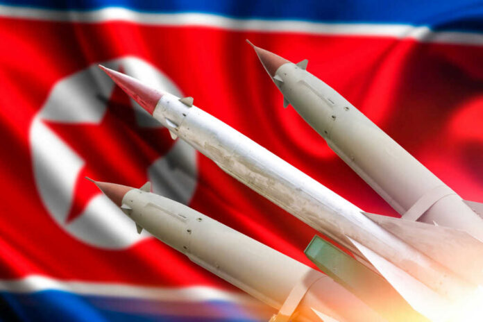 Missiles in front of a North Korean flag