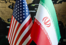 Iran’s Nuclear Pause–Truth or Mere Stalling? Flags of the United States and Iran displayed together