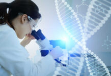 Scientist examining a sample under a microscope in a lab
