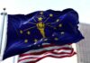Indiana state flag waving in front of an American flag
