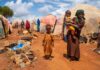 Children in a makeshift camp on a dry, dusty ground