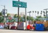 Zero Tolerance: Bold Plan to Erase LA Encampments Homeless tents along a city street near a highway sign