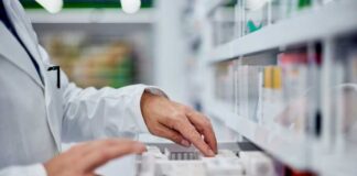 Pharmacist organizing medication on a shelf