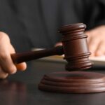 Supreme Court Snubs NFL—Discrimination Suit Unleashed A judge's hand holding a gavel above a wooden block
