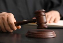 Supreme Court Snubs NFL—Discrimination Suit Unleashed A judge's hand holding a gavel above a wooden block