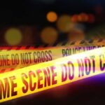 Gunmen’s Vicious Strike: Police Among 25 Dead Yellow police tape marking a crime scene with blurred lights in the background