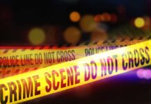 Gunmen’s Vicious Strike: Police Among 25 Dead Yellow police tape marking a crime scene with blurred lights in the background