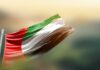 Flag of Sudan waving in the wind against a blurred background